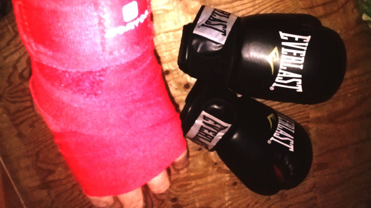 indoors, still life, table, high angle view, close-up, communication, wood - material, red, technology, no people, paper, pink color, variation, text, bottle, two objects, single object, book, black color, selective focus