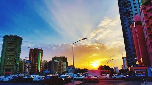 Traffic on road at sunset