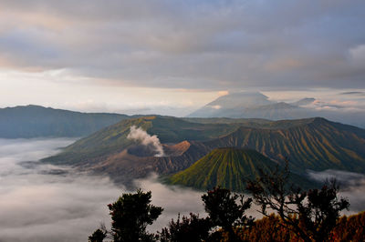 Scenic view of mountains against cloudy sky