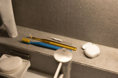 Various toothbrushes with dental floss in the bathroom