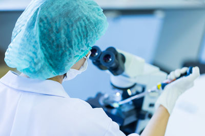 Rear view of woman working in laboratory