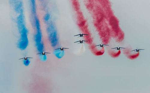 Low angle view of airshow against sky