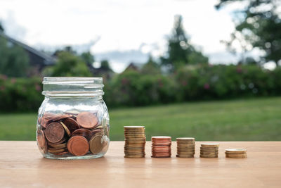 Close-up of coins in jar on table