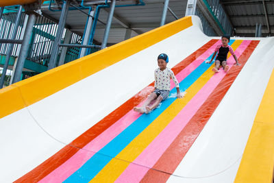 High angle view of men playing with multi colored umbrella