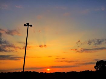 Low angle view of silhouette street light against sky during sunset