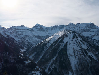 Scenic view of snowcapped mountains against sky