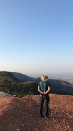 Full length of man standing on mountain against sky