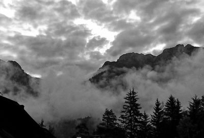 Scenic view of mountains against cloudy sky