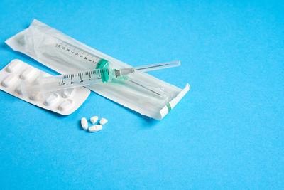 High angle view of blue paper over white background