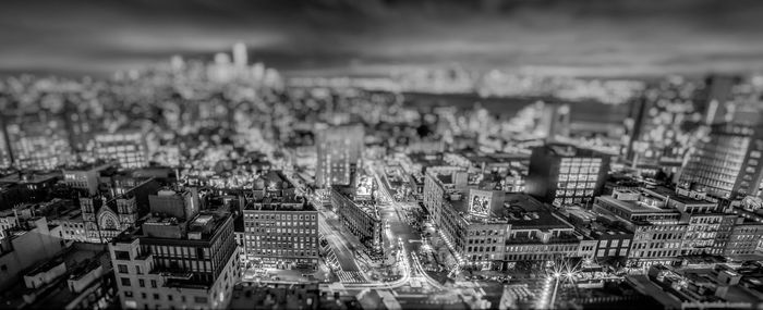 Tilt-shift image of cityscape against sky