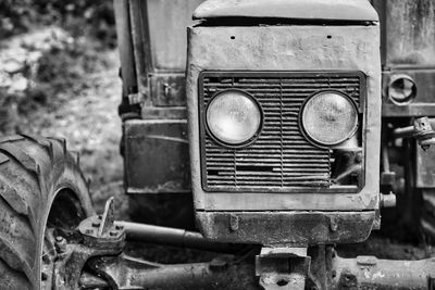 Old abandoned vintage tractor on field