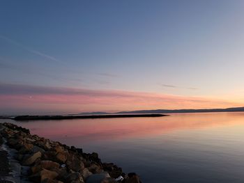 Scenic view of lake against sky during sunset