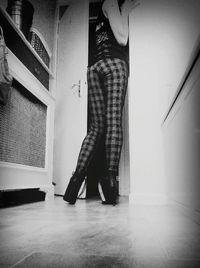 Rear view of woman standing on floor