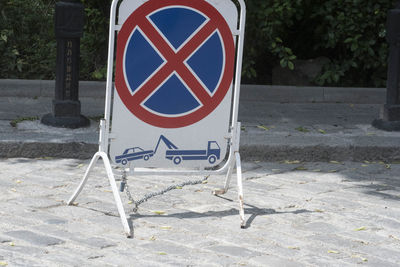 Arrow sign on road in city