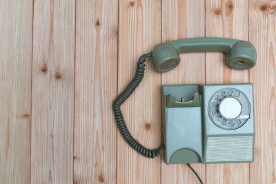 Close-up of old telephone on table