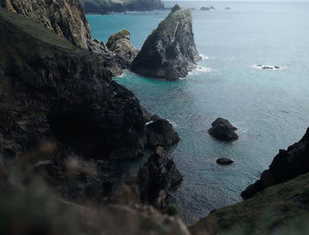 Rock formation in sea against sky