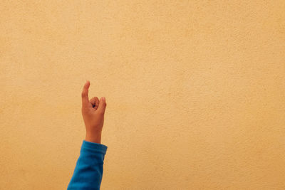 Close-up of hands against wall