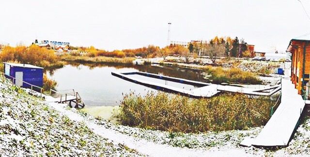 nautical vessel, lake, water, transportation, boat, moored, snow, mode of transport, cold temperature, clear sky, tranquility, built structure, winter, tranquil scene, season, reflection, pier, nature, scenics, plant, standing water, growth, calm, sky, non-urban scene, no people, solitude, canal, remote