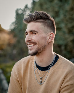 Portrait of young man smiling outdoors