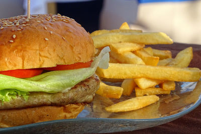 Close-up of burger and fries on table