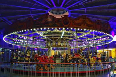 Illuminated carousel at night