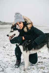 Full length of woman wearing hat on field during winter