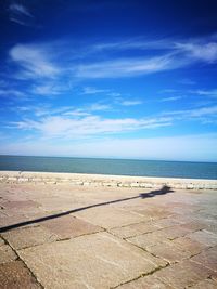 Scenic view of beach against blue sky