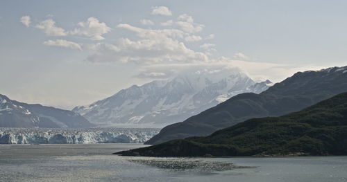 Hubbard glacier by mountains against sky