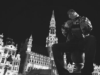 Low angle view of statue in city at night