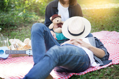 Low section of mother and daughter in park