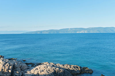 Scenic view of sea against clear blue sky