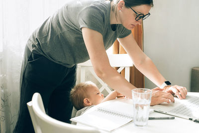 Side view of young man working at home