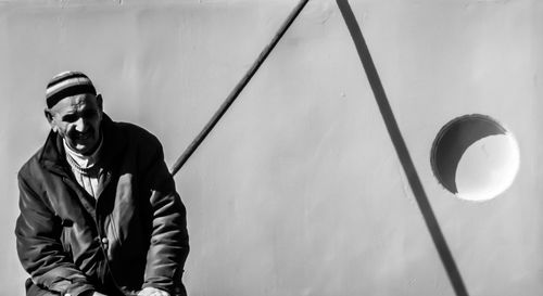 Portrait of young man against wall