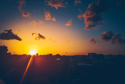 Silhouette buildings against sky during sunset