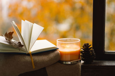 Sweater, candle and autumn decor. autumn home decor.