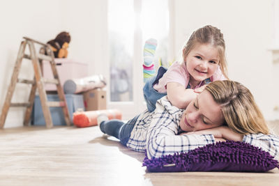 Mother and daughter having a break in new home