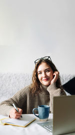 Young woman using laptop at table