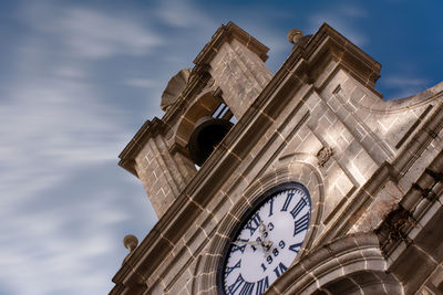 Low angle view of clock tower against sky