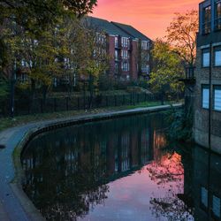 Reflection of buildings in lake during autumn