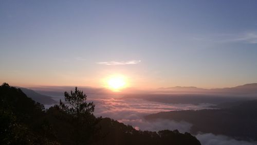 Scenic view of silhouette mountains against sky at sunset