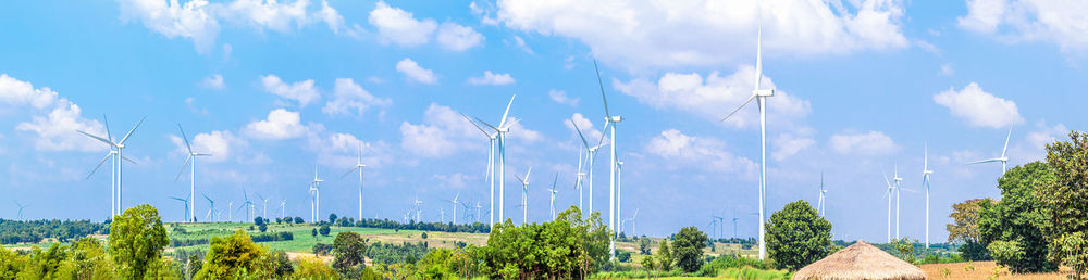 Panoramic shot of trees on land against sky