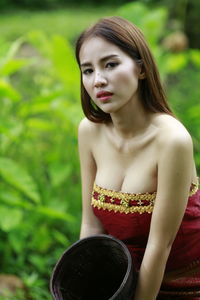 Portrait of young woman sitting outdoors