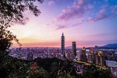 View of modern buildings against sky during sunset