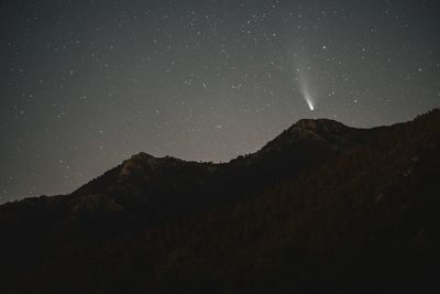 Scenic view of mountains against sky at night
