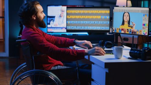 Side view of man sitting on wheelchair