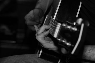 Cropped image of musician playing guitar