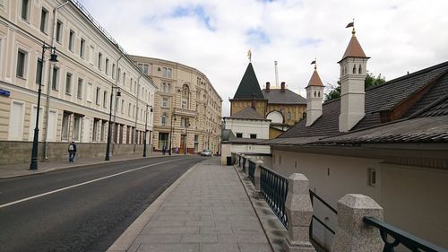 Street amidst buildings in city against sky