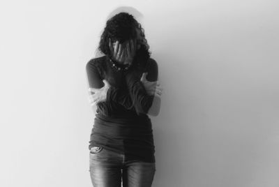 Young woman standing against white background