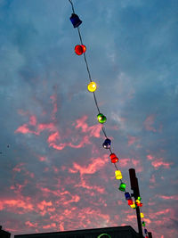 Low angle view of colorful umbrellas hanging against clear sky