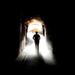 Rear view of silhouette man in tunnel